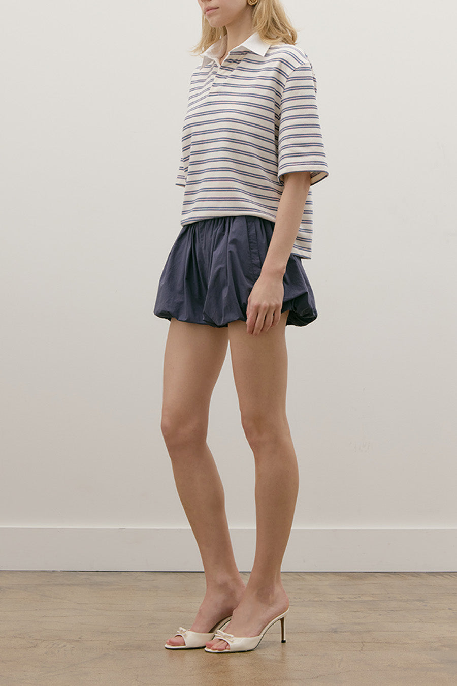 Crafted from a soft, finely knit fabric, it features classic navy and ivory stripes that offer effortless elegance and enduring appeal.