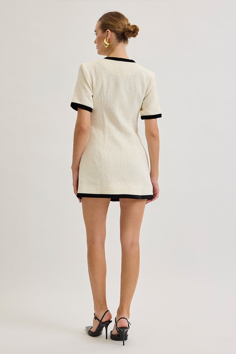 Short sleeves and clean lines lend a sophisticated balance, while subtle pocket detailing enhances its classic appeal