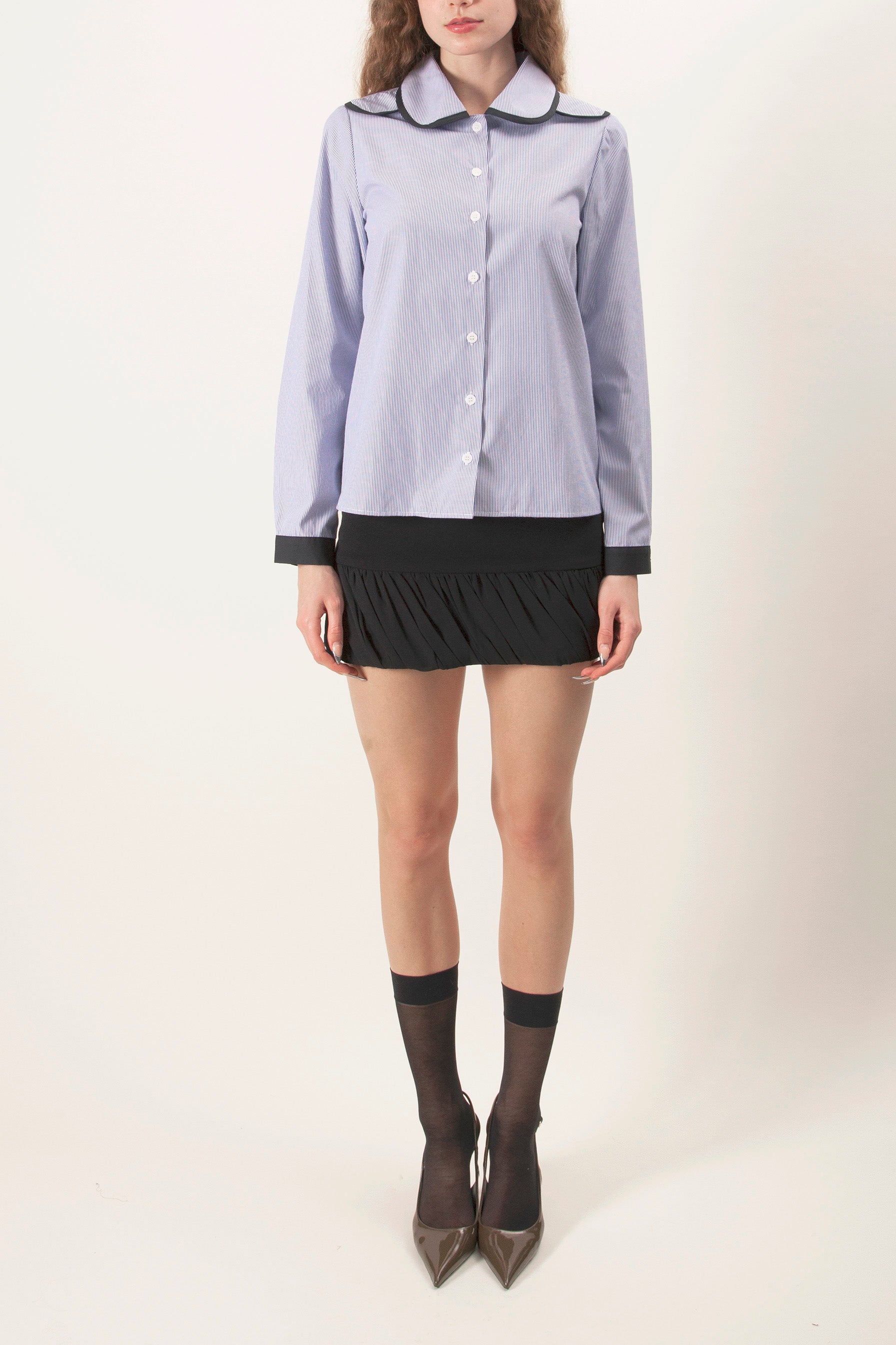 This refined button-front shirt is crafted in a crisp blue-and-white striped fabrication, offering a timeless pattern elevated through thoughtful design