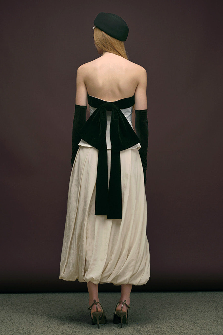 The clean, architectural silhouette gently flares at the hem, creating a flattering and modern shape.