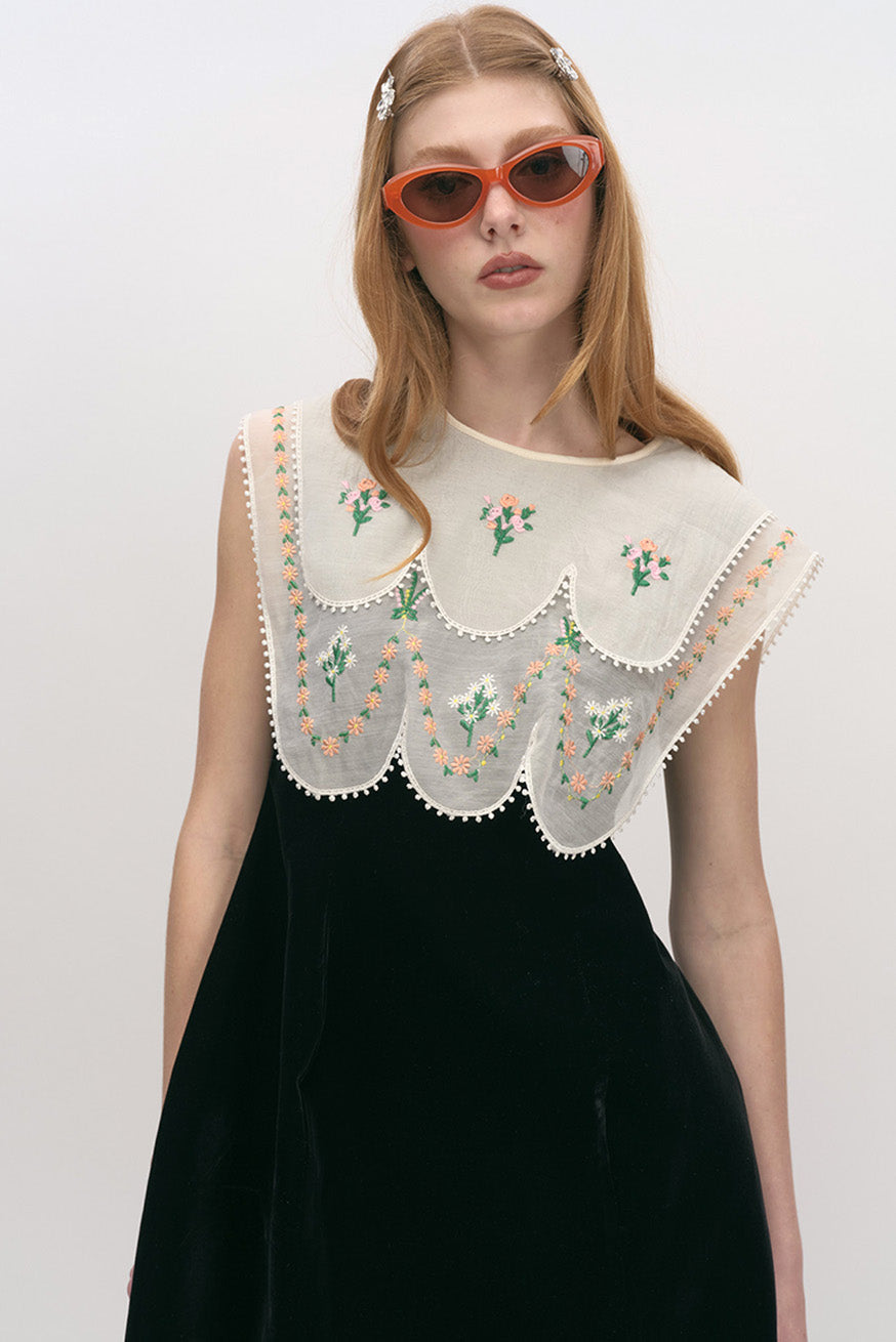 sculptural black mini dress with ornate embroidered scalloped bib and couture detailing