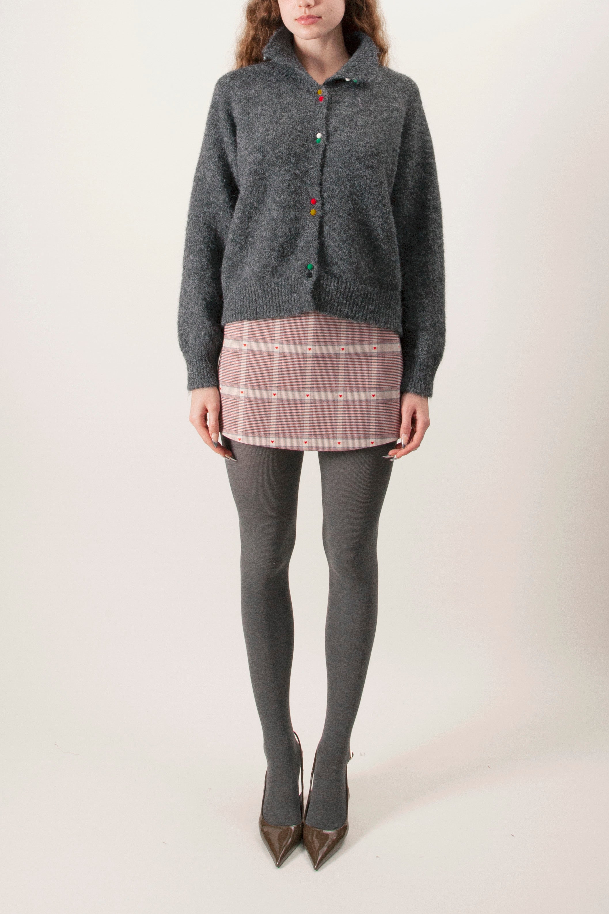 This refined knit cardigan is crafted in a soft charcoal melange, offering understated luxury through texture and detail.