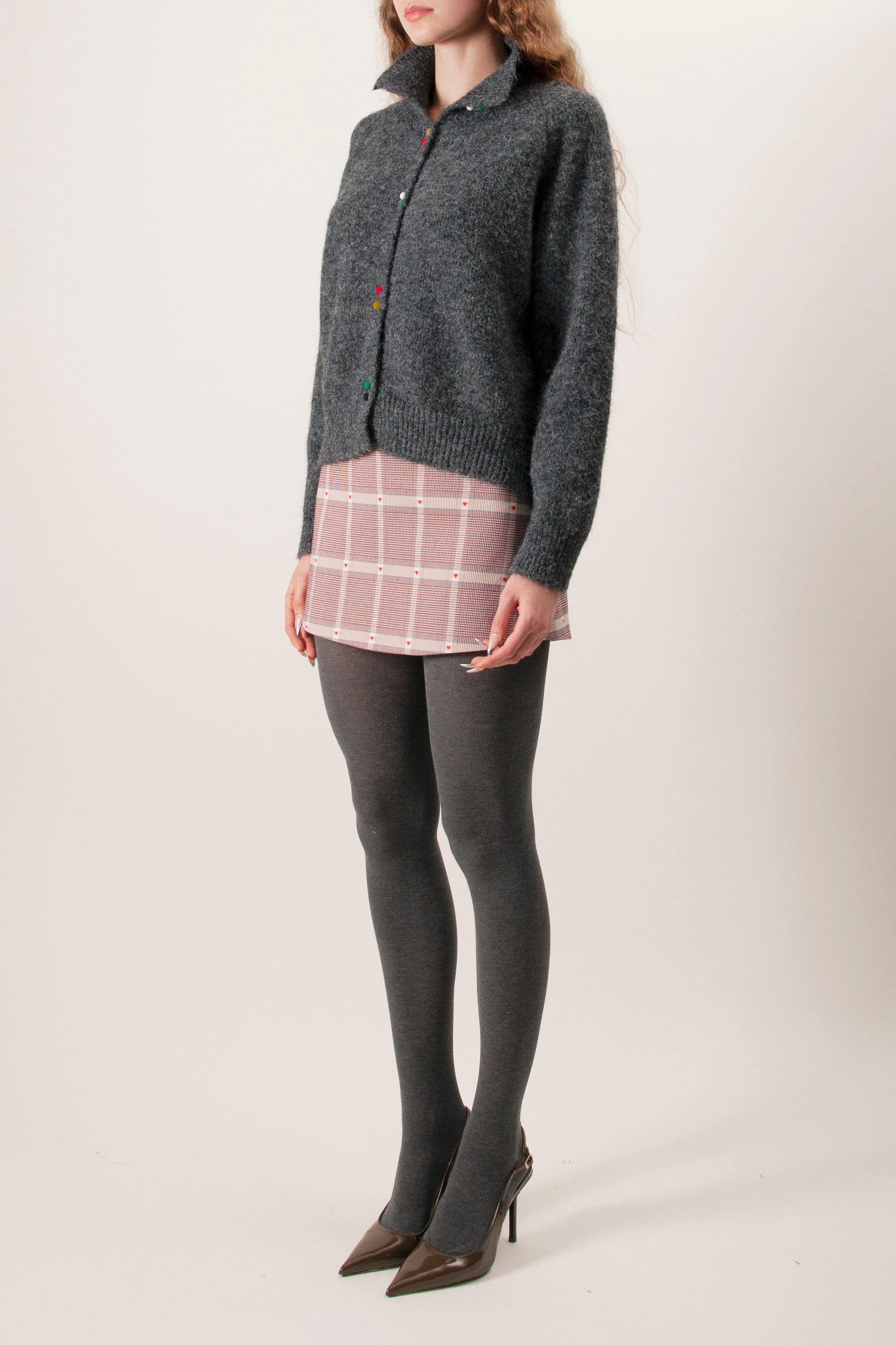 Designed with a relaxed yet polished silhouette, it features a clean round neckline and a row of delicate multicolour buttons that add a discreet artisanal accent.