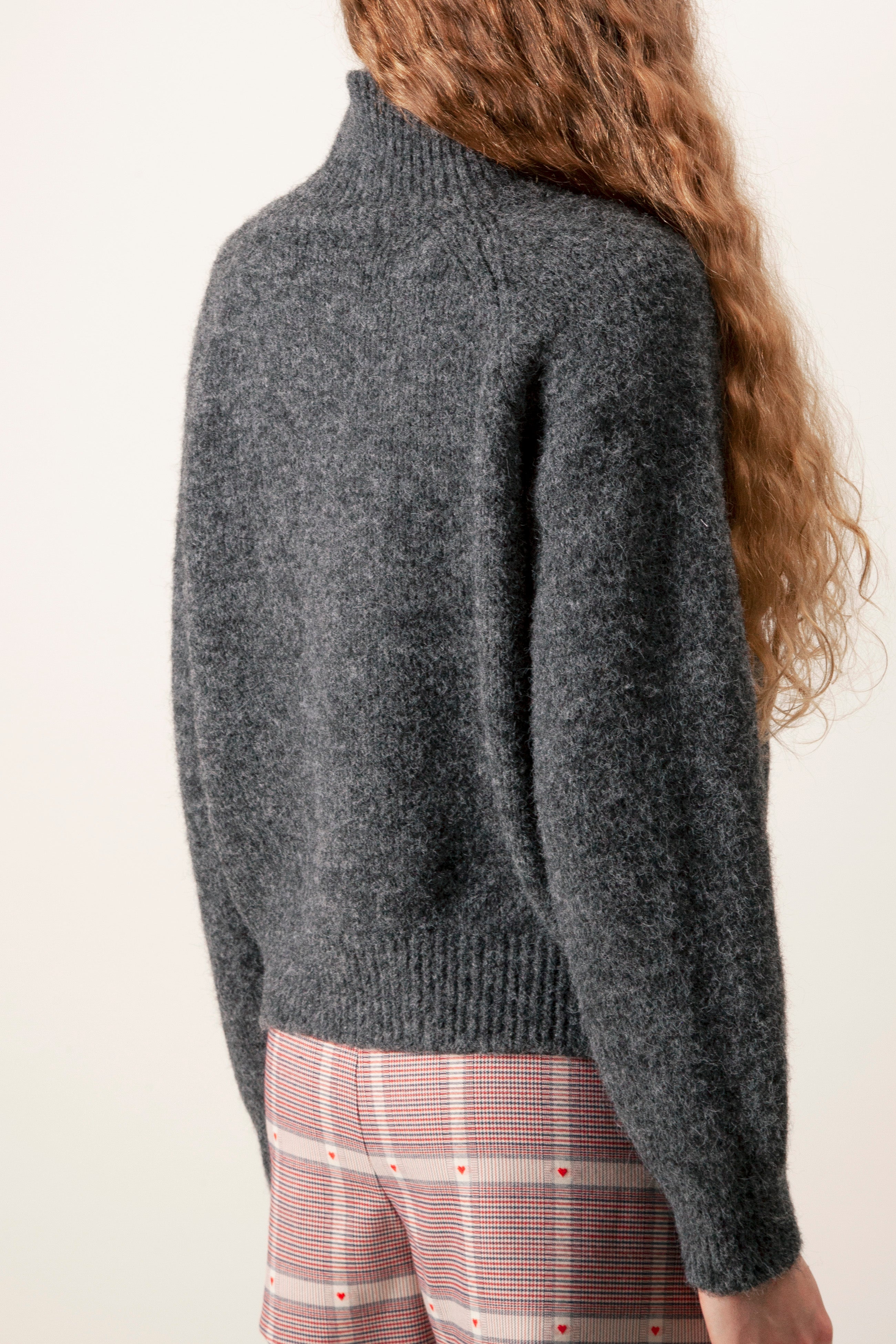 The plush knit construction provides warmth without bulk, making it an effortless layering piece for elevated everyday dressing.