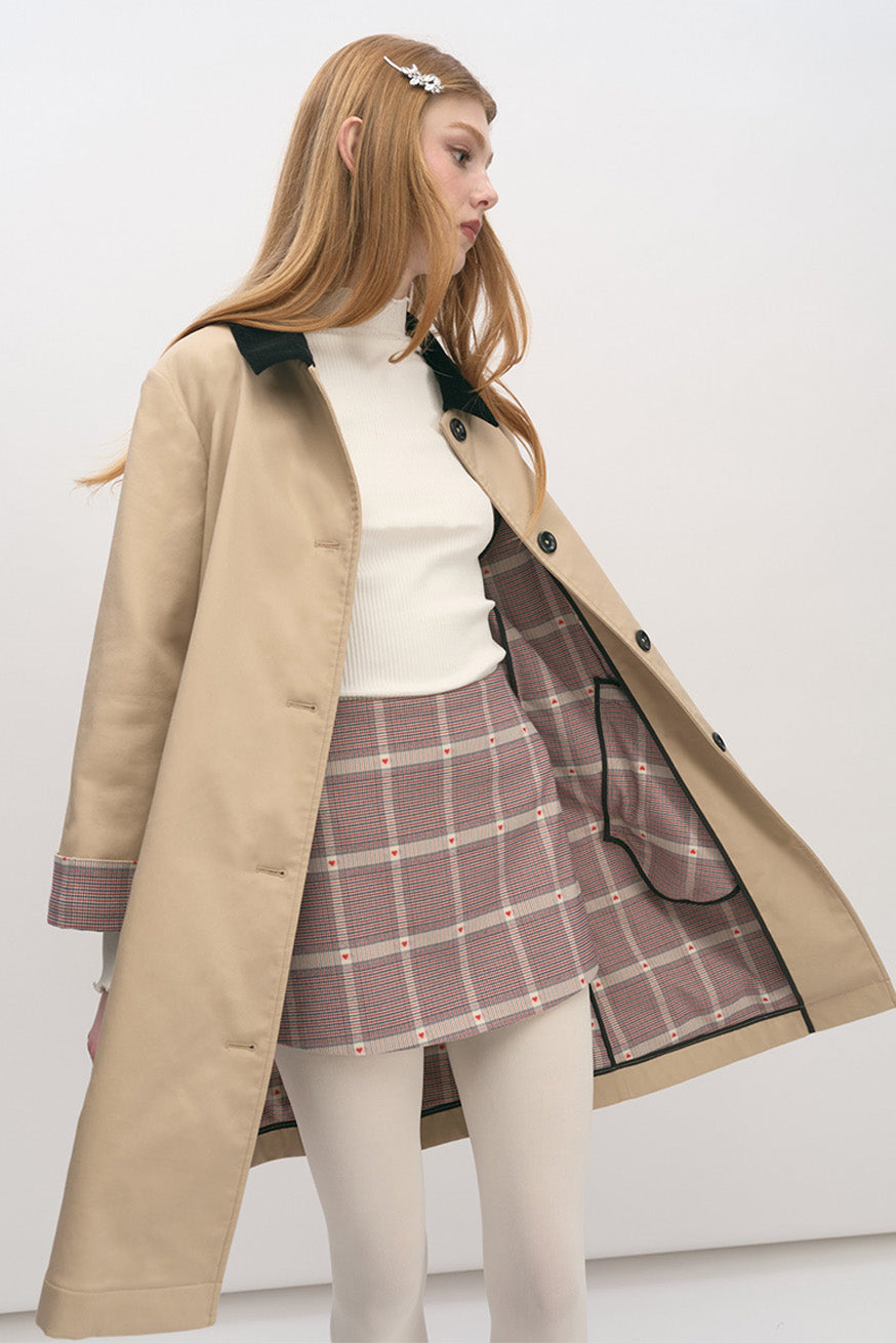 refined beige coat with contrast collar, subtle plaid cuff detailing, and timeless silhouette