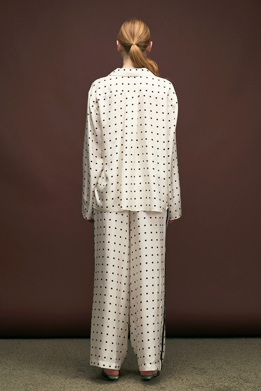 ivory base with refined polka-dot pattern, fluid silhouette, and elegant gold-tone buttons