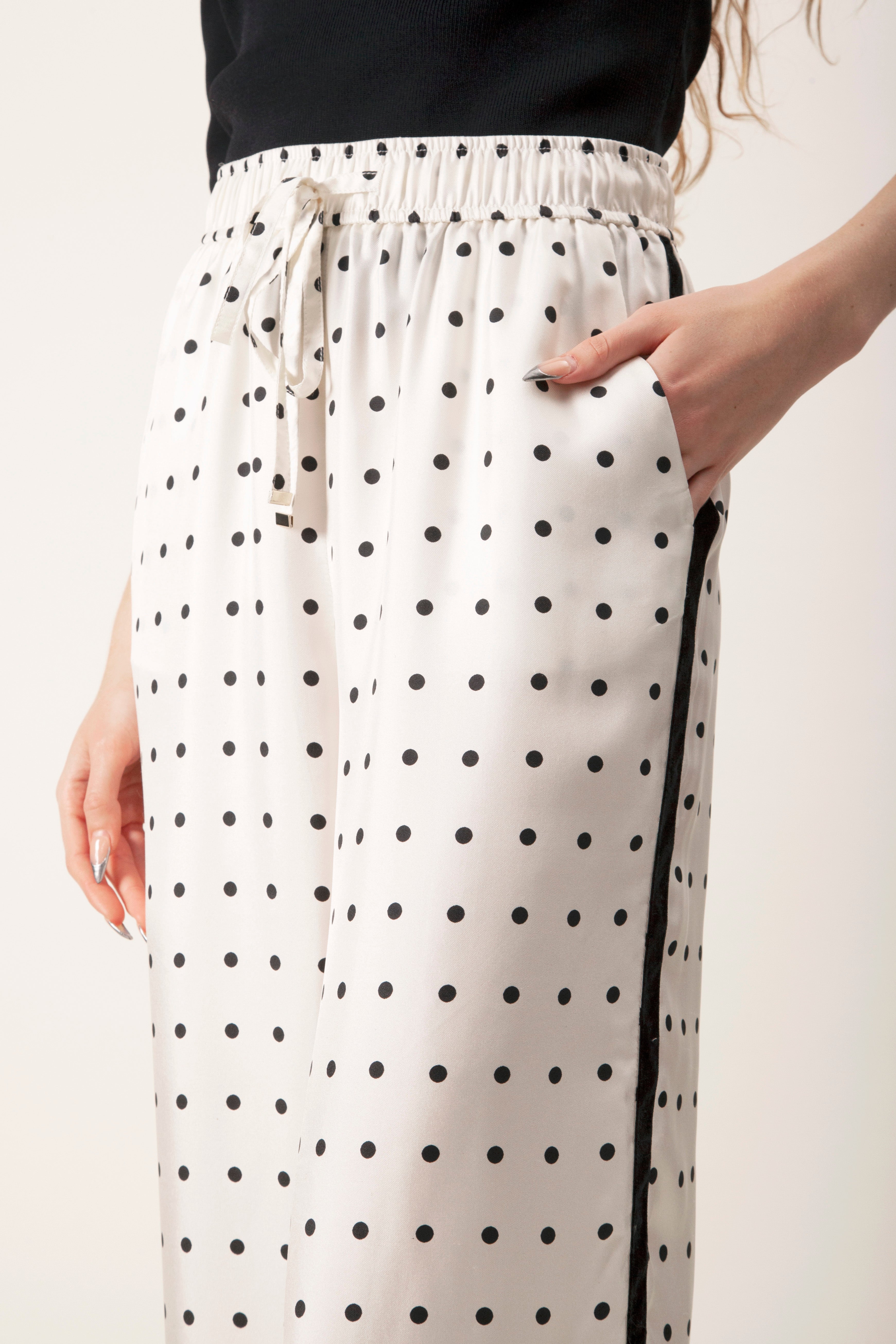 The fluid drape and polished finish make these pants a versatile luxury piece, ideal for elevated daywear or refined lounge-to-evening styling.