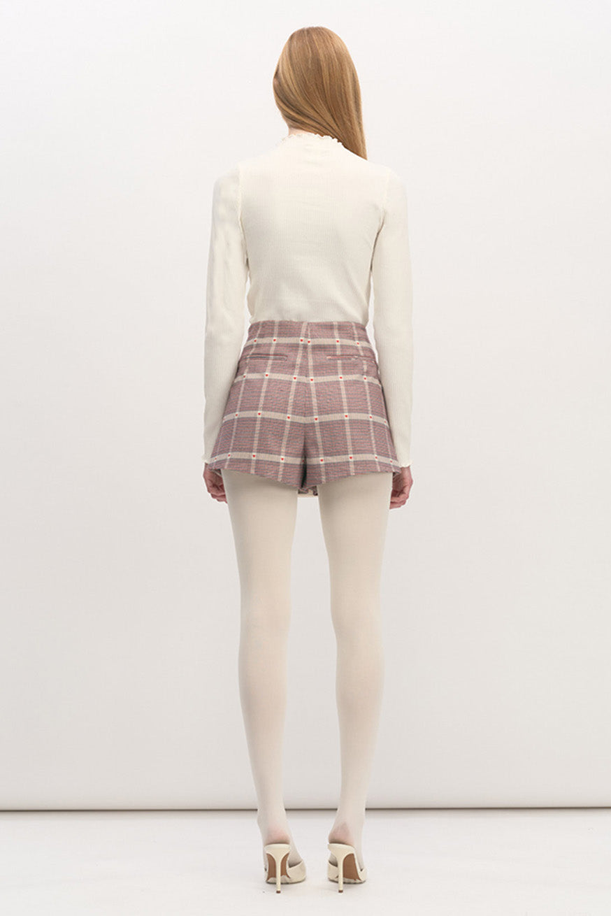 The intricate weave and playful detailing bring a modern romantic sensibility to a classic form, making this skirt a distinctive luxury piece that elevates both daywear and contemporary styling.