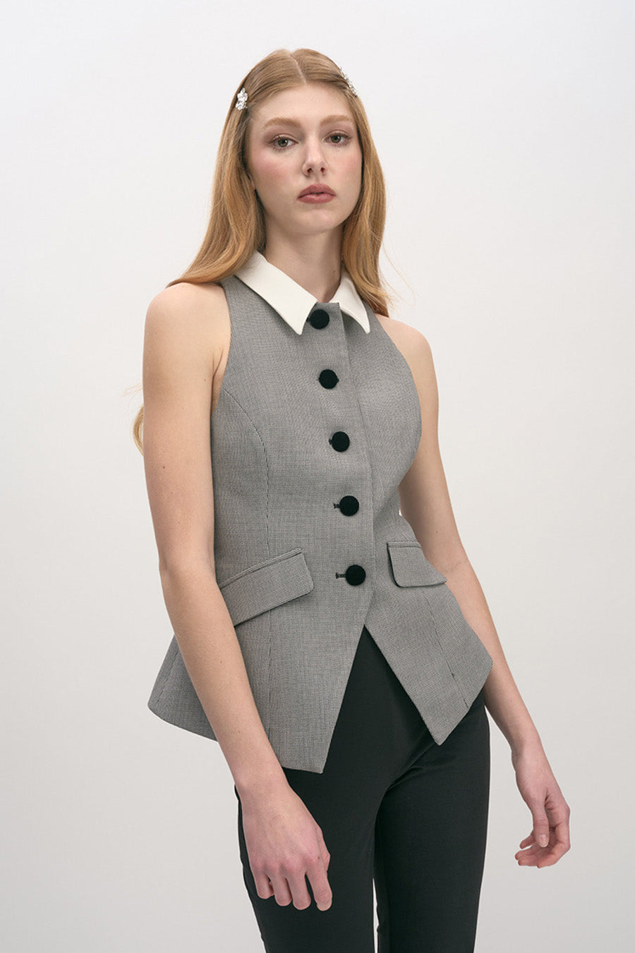 A refined interpretation of modern tailoring, this sleeveless vest top is designed to elevate everyday dressing with architectural precision