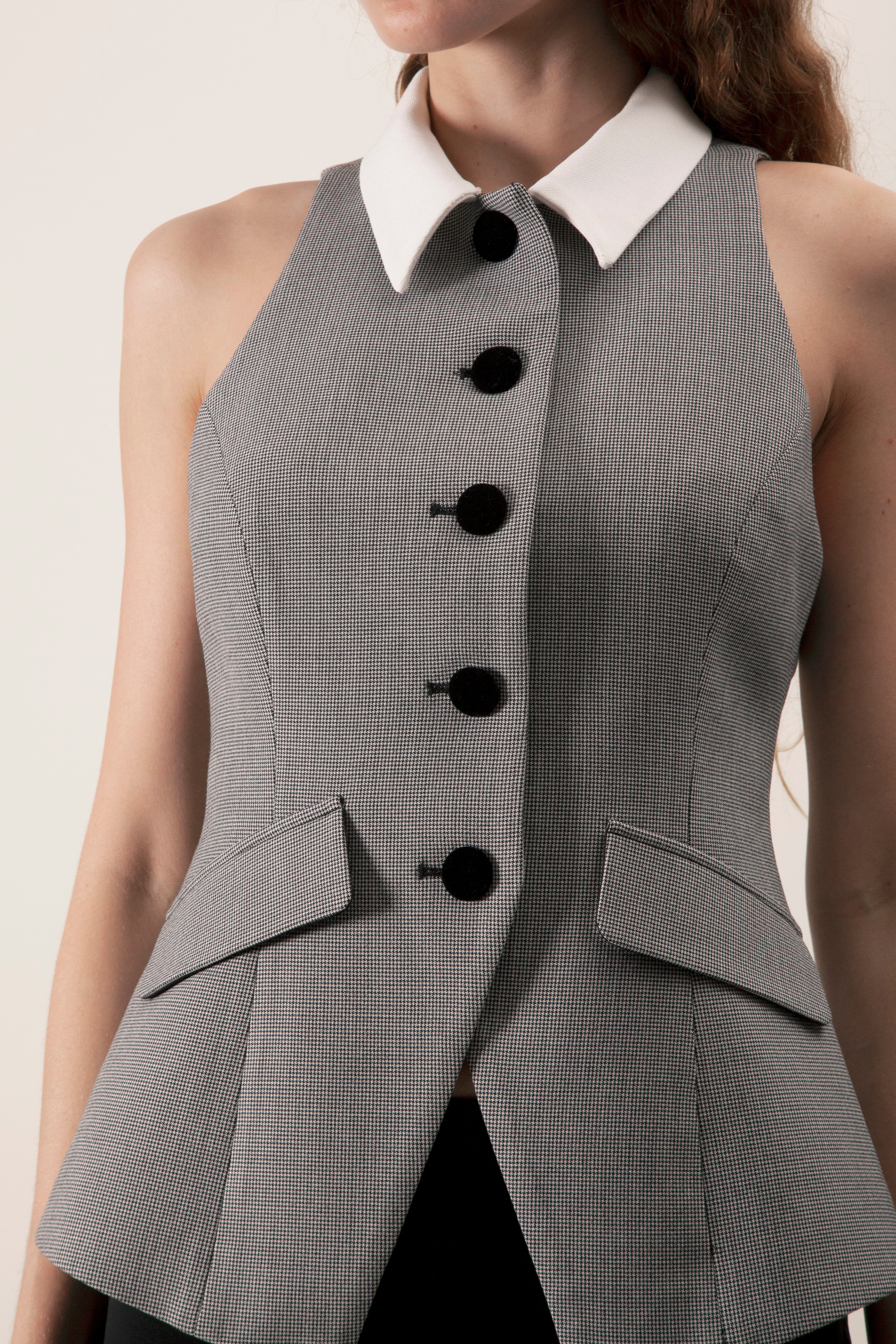 Cut to contour the waist, it features a clean contrast collar and a row of statement buttons that lend a polished, directional finish.