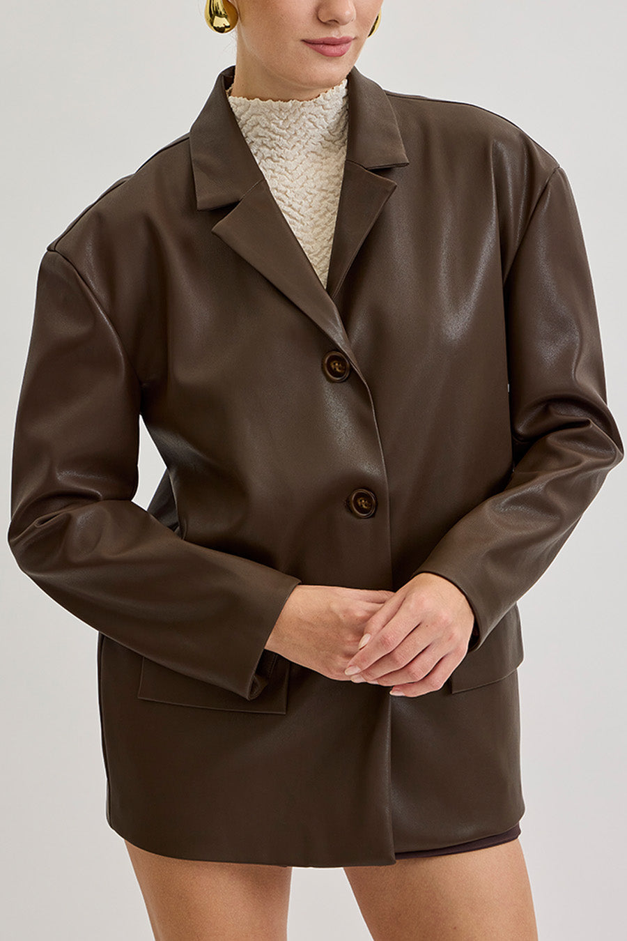 Expertly crafted in supple leather with a smooth hand feel, it features a structured silhouette, notched lapels, and refined button detailing that exude understated power and elegance.