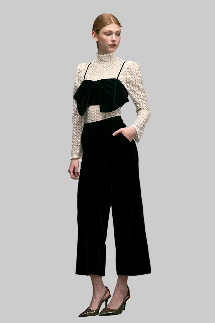 Crafted in a sleek solid black fabric, the pants feature a clean, tailored waistline that flatters the figure while flowing into a relaxed wide-leg silhouette for comfort and movement.