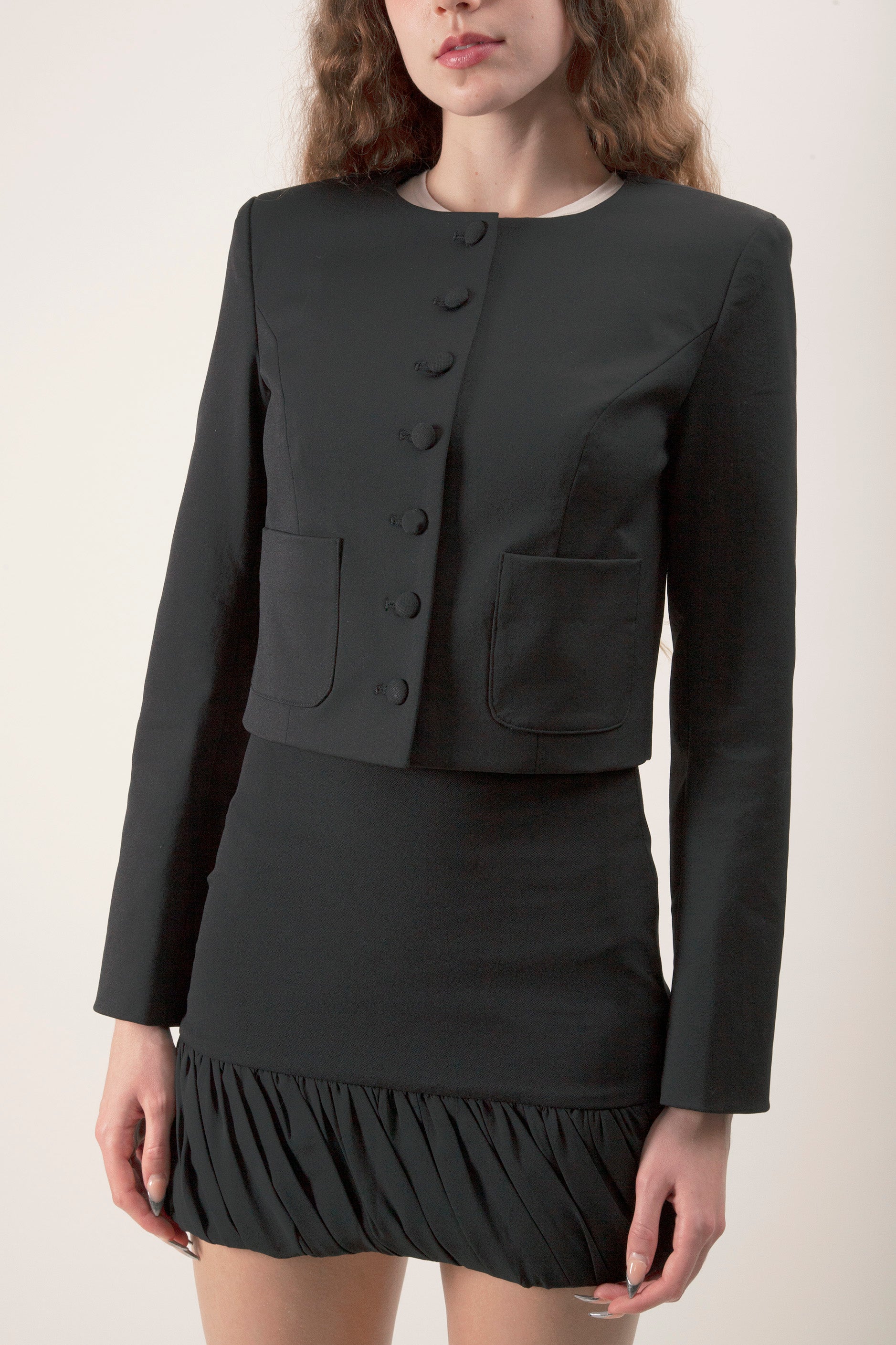 Sharp lines and a fitted shape create a polished, architectural finish.