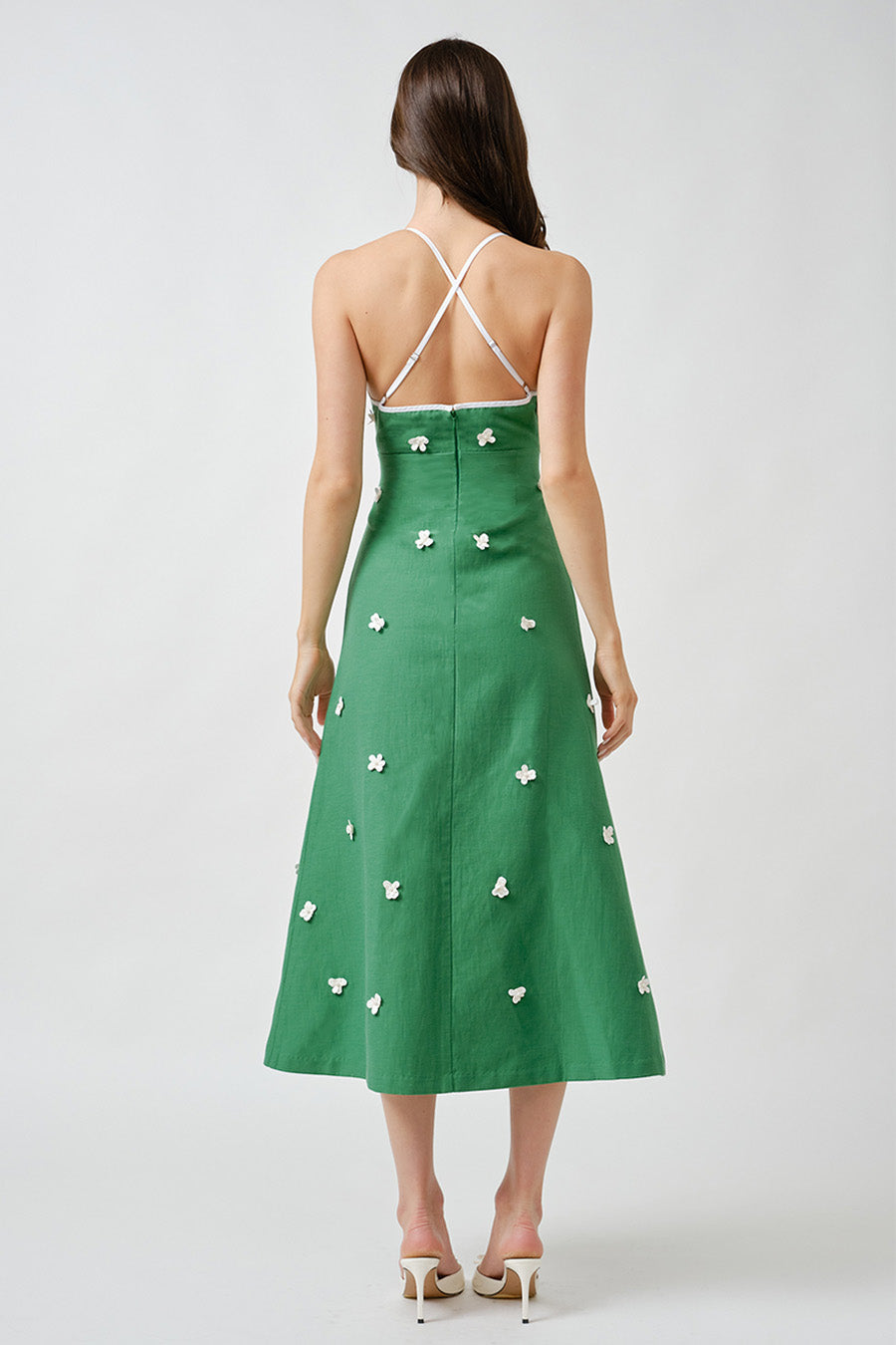 Hand-applied floral embellishments are scattered across the body, adding texture and dimensional beauty while elevating the clean lines of the design