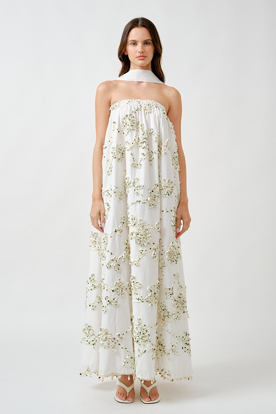 A vision of ethereal elegance, this luxury maxi dress is designed to captivate with its delicate craftsmanship and fluid silhouette.