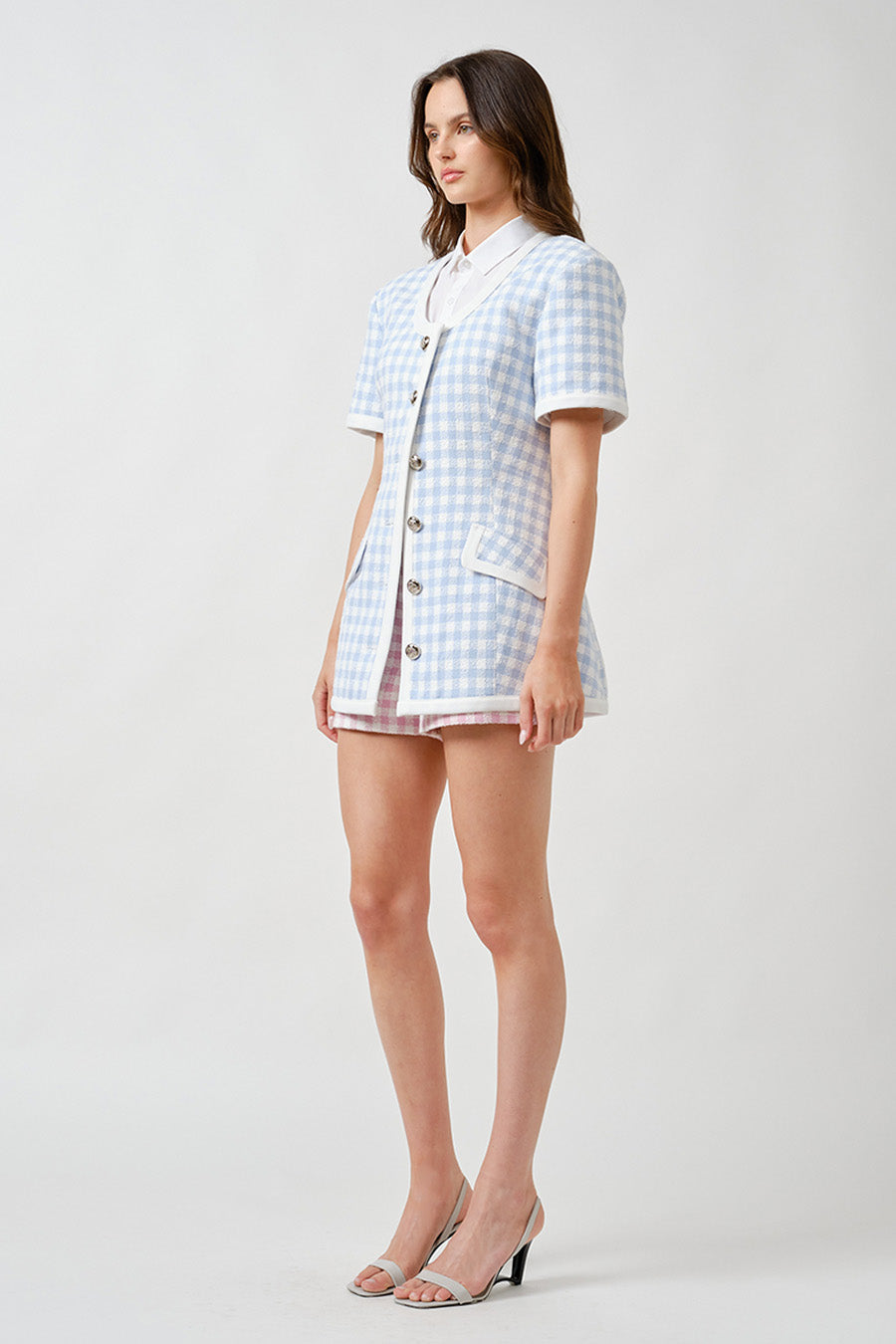 The light blue and ivory palette evokes timeless sophistication, while the tailored fit and front patch pockets offer both polish and practicality.