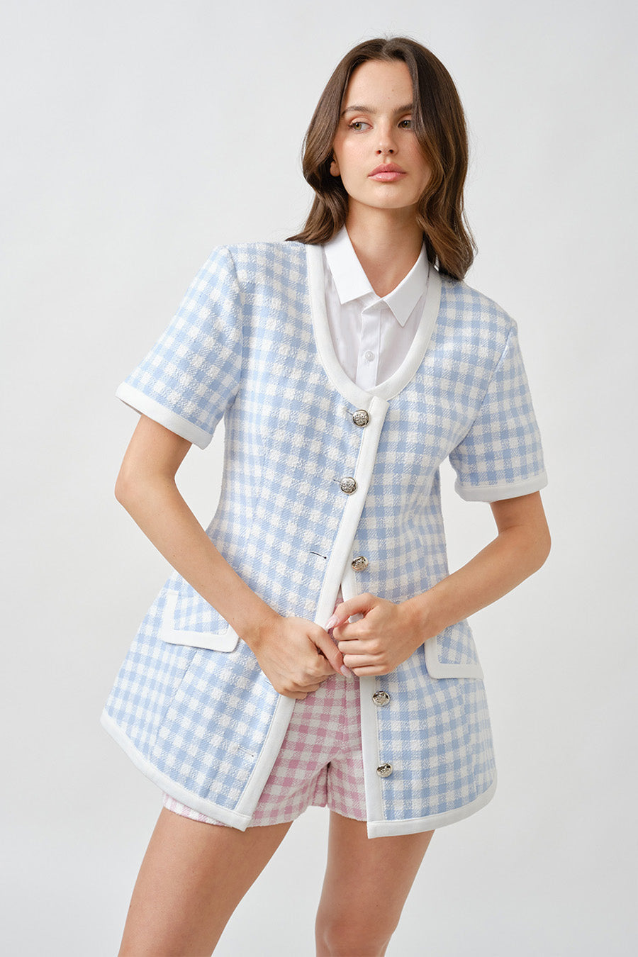 A modern interpretation of classic tailoring, this luxury short-sleeve jacket is crafted in a refined gingham weave that balances structure with effortless femininity.