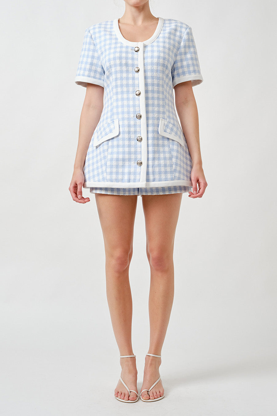Crafted in a delicate gingham-inspired weave, the silhouette is clean and modern, sitting smoothly at the waist with a flattering, elongating line.