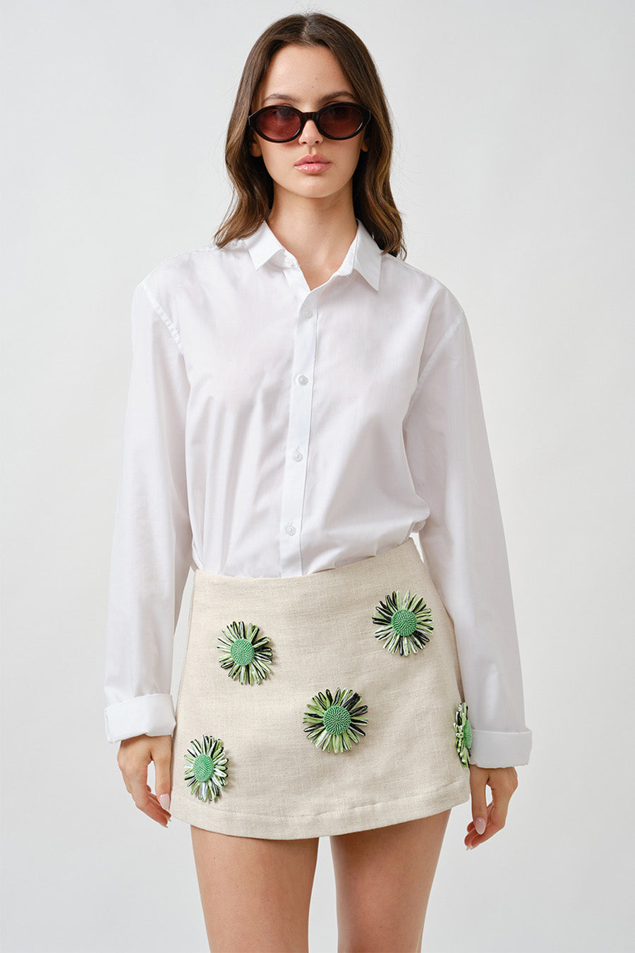 An artful expression of modern femininity, this luxury mini skirt is crafted in a refined, natural-textured fabrication that offers both structure and elegance.