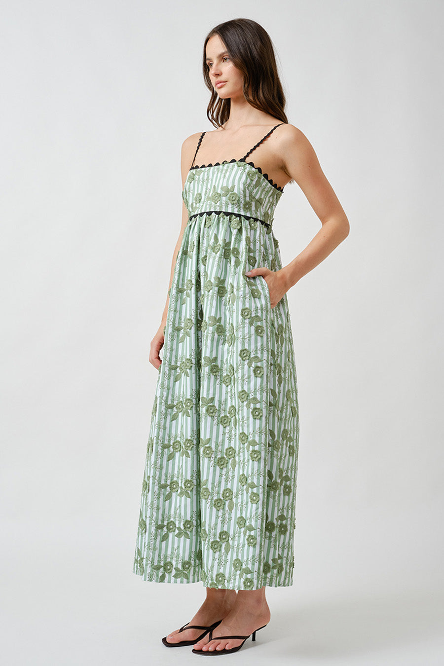 Delicate shoulder straps frame the neckline, while subtle contrast detailing adds a refined, couture-inspired finish.