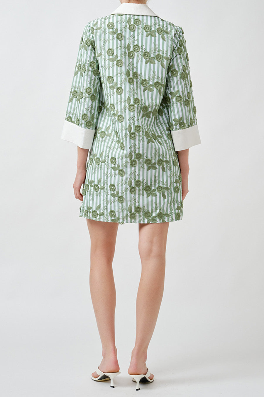 The delicate vertical stripe pattern is layered with an intricate floral motif, creating depth, texture, and a subtle elongating effect.