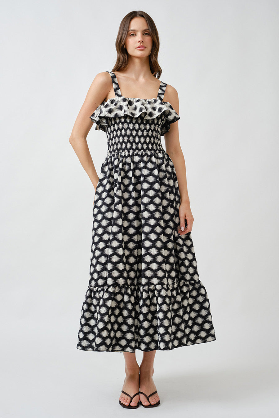 An elevated expression of effortless elegance, this luxury midi dress is crafted with a softly smocked bodice that contours the figure while offering graceful comfort.