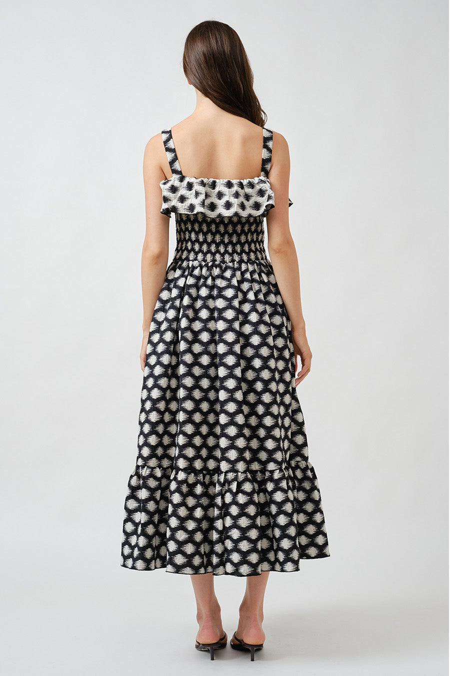 The intricate monochrome pattern lends visual depth and artisanal character, while slender shoulder straps keep the look light and feminine