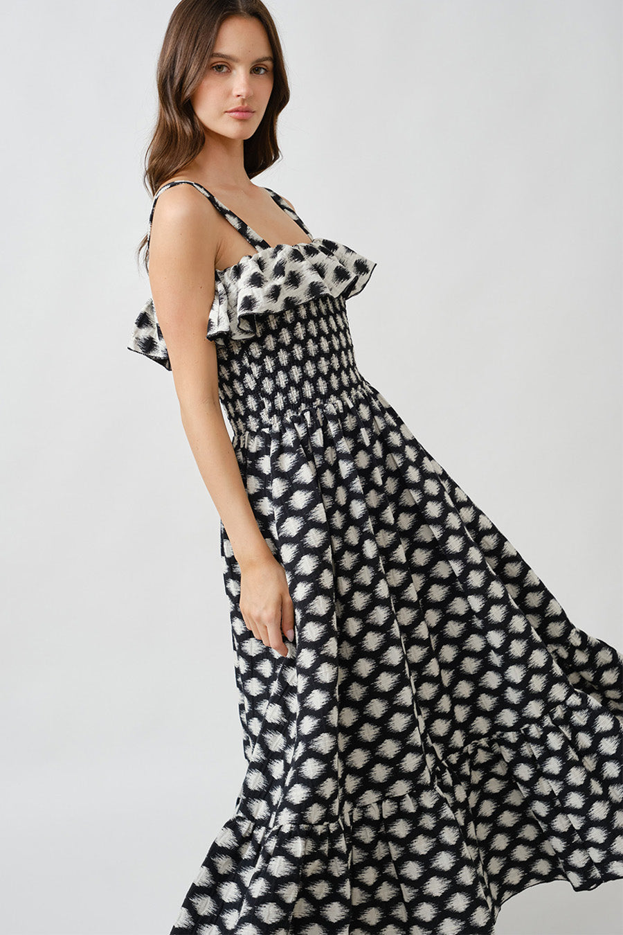 Designed to flow beautifully with every step, this dress transitions seamlessly from sunlit daytime occasions to refined evening moments.