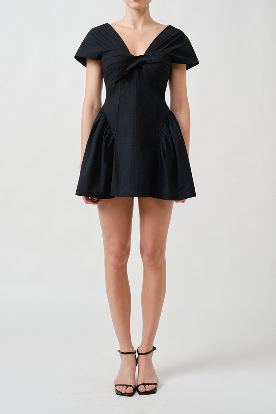 Sculptural and irresistibly refined, this luxury black mini dress is a modern expression of feminine architecture.