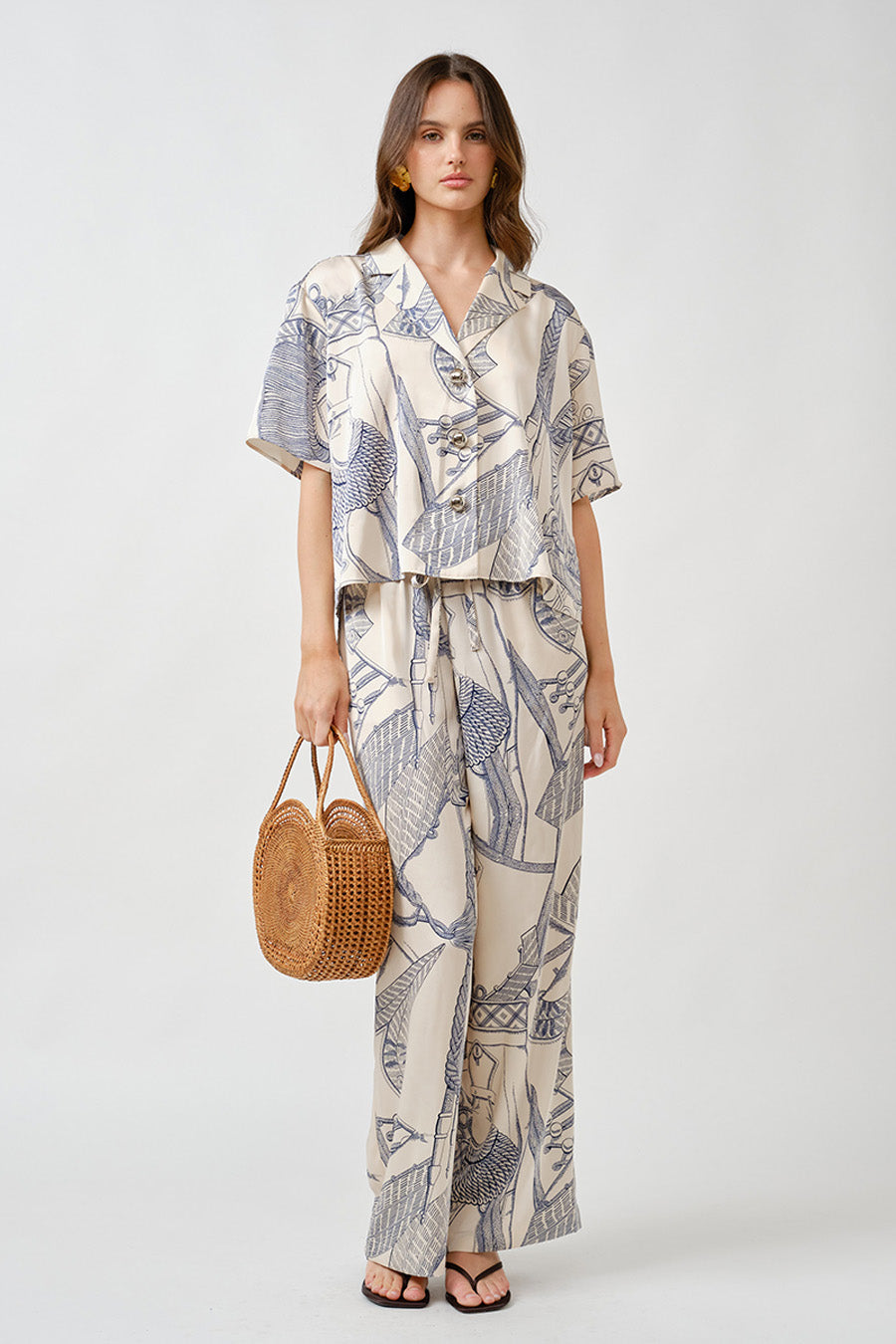 Designed with a softly structured lapel neckline and a fluid silhouette, it offers a polished yet relaxed drape that transitions seamlessly from day to evening.