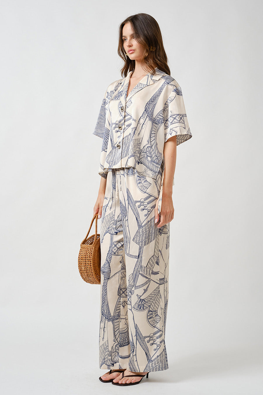 The intricate blue linework print—set against a warm ivory base—evokes hand-drawn elegance and timeless craftsmanship, while subtle tailoring details lend a contemporary edge.