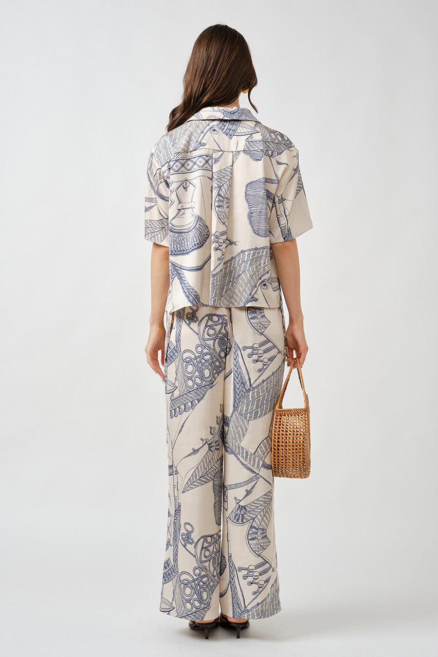 Lightweight and breathable, this piece is ideal for elevated warm-weather styling or layered refinement.