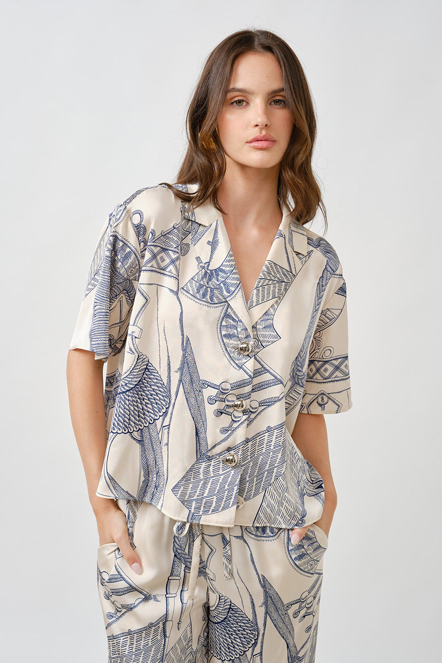 A refined fusion of artistry and modern tailoring, this printed short-sleeve top redefines effortless sophistication.