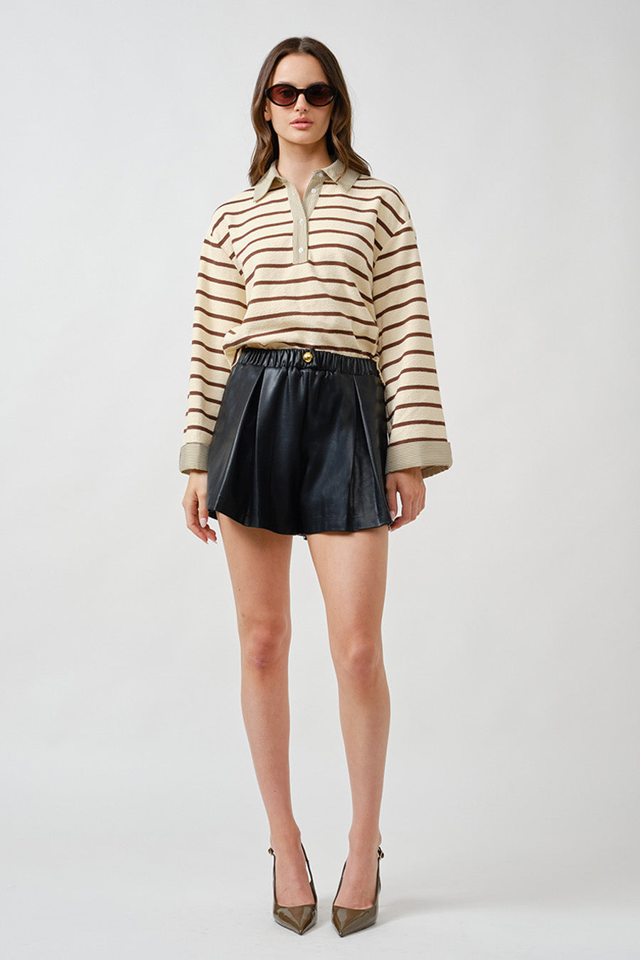 An elevated interpretation of casual refinement, this luxury striped polo top blends timeless pattern with modern sophistication