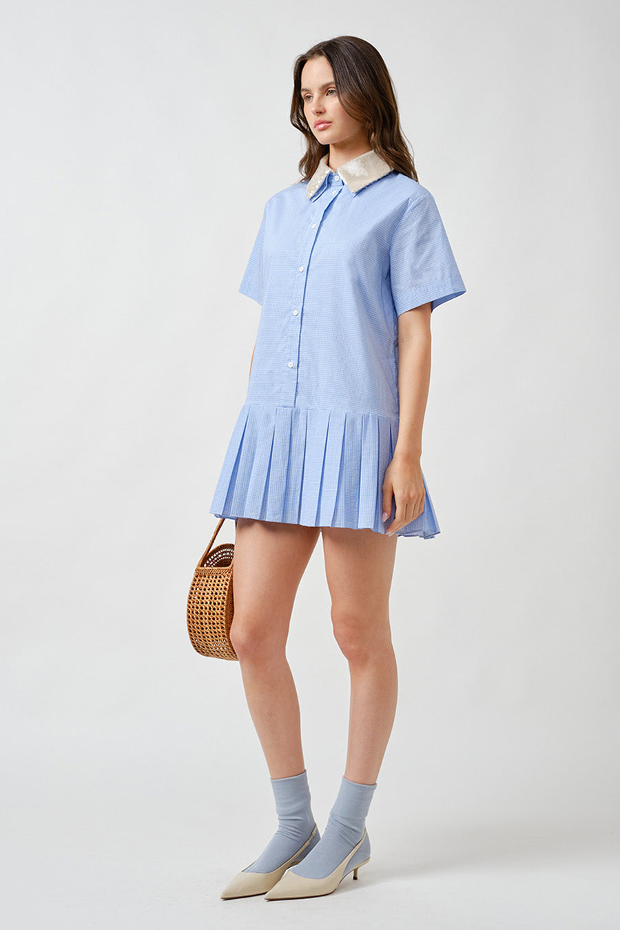 Crafted in crisp, lightweight cotton, it features a classic button-front silhouette elevated by a delicately embellished contrast collar for a polished finishing touch.