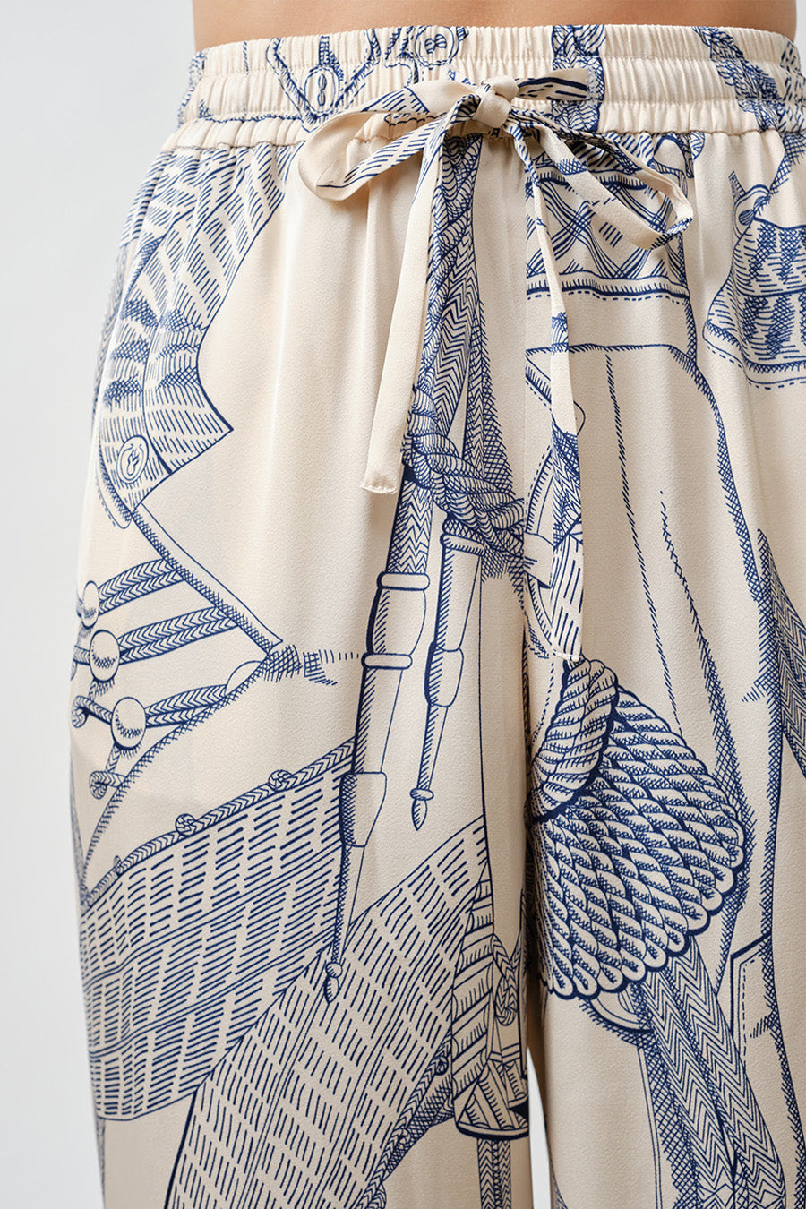 The statement print—rendered in soft blue linework against a warm ivory base—adds a graphic yet timeless appeal, evoking a sense of curated elegance and modern artistry.