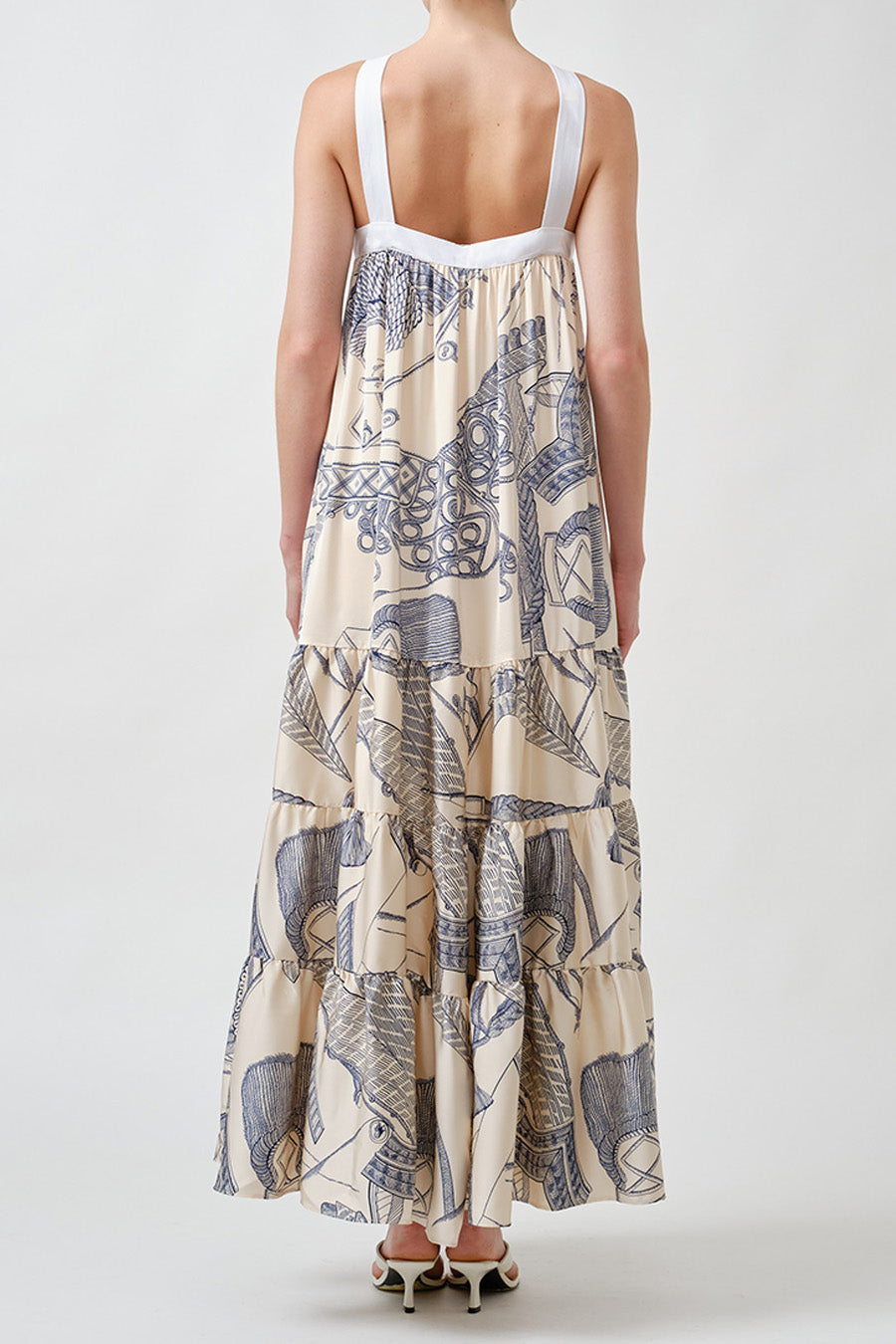 Finished with an intricate illustrated print in contrasting tones, this piece evokes artisanal craftsmanship while maintaining a modern, resort-ready elegance.