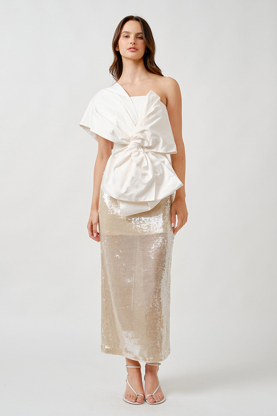 A sculptural statement of modern elegance, this one-shoulder top is designed to captivate with architectural precision