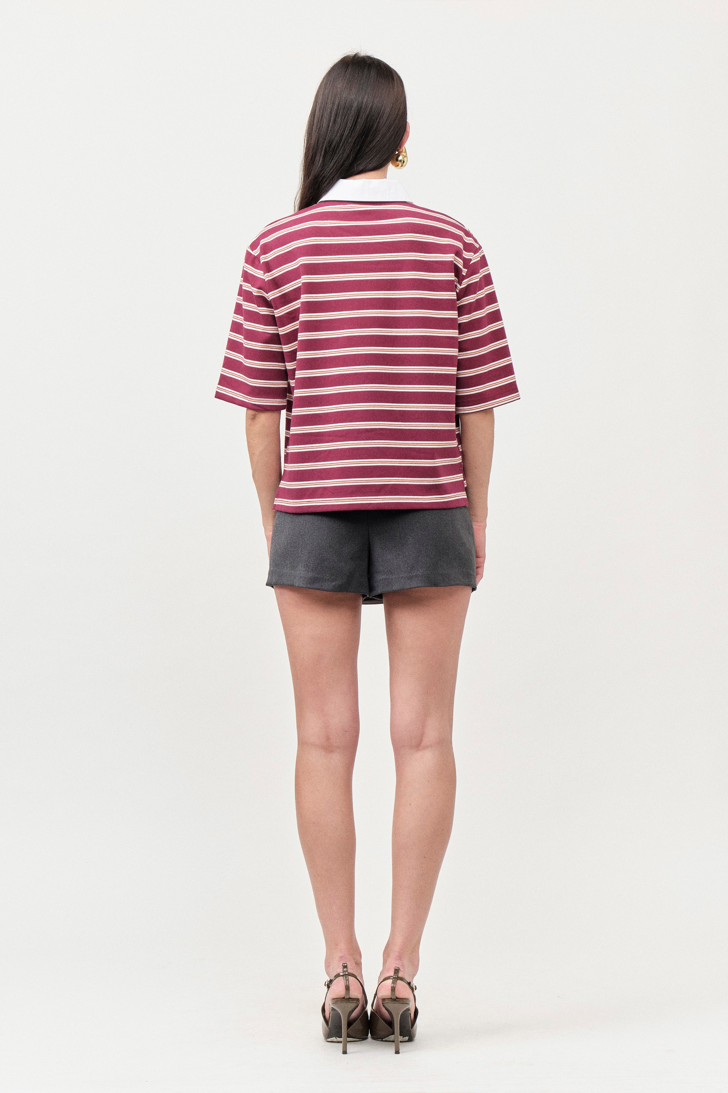 The boxy yet flattering cut offers effortless wearability, while the structured collar and clean neckline lend a modern, collegiate-inspired elegance.