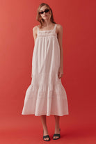 Finished with slender shoulder straps and a fluid hemline, this dress transitions seamlessly from sunlit daytime occasions to elegant resort evenings.