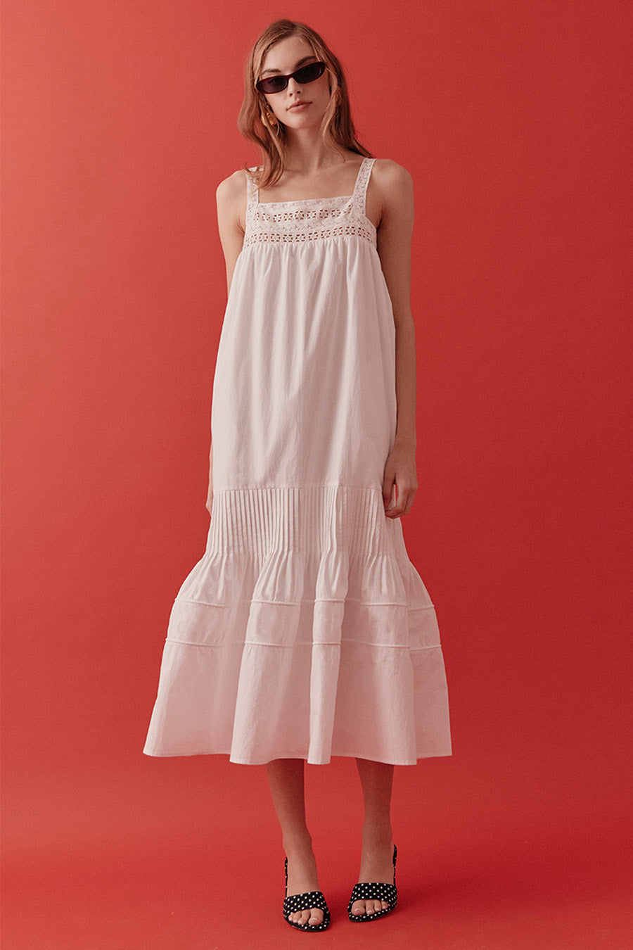 Finished with slender shoulder straps and a fluid hemline, this dress transitions seamlessly from sunlit daytime occasions to elegant resort evenings.