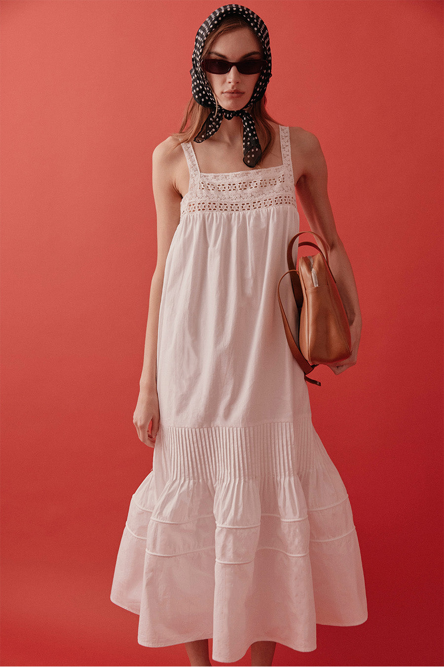 An ode to effortless femininity, this luxury midi dress is crafted in an airy, lightweight fabrication that drapes beautifully with every step