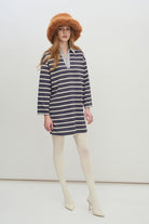 Designed with a soft knit fabric, the top features classic horizontal stripes in a muted navy and cream color palette for a clean, nautical-inspired look.