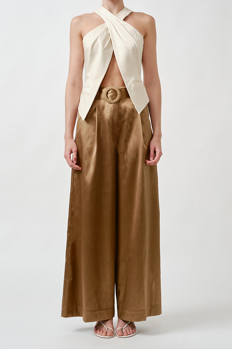 A sculptural expression of modern elegance, this halter-style wrap top is designed to command attention with understated confidence.