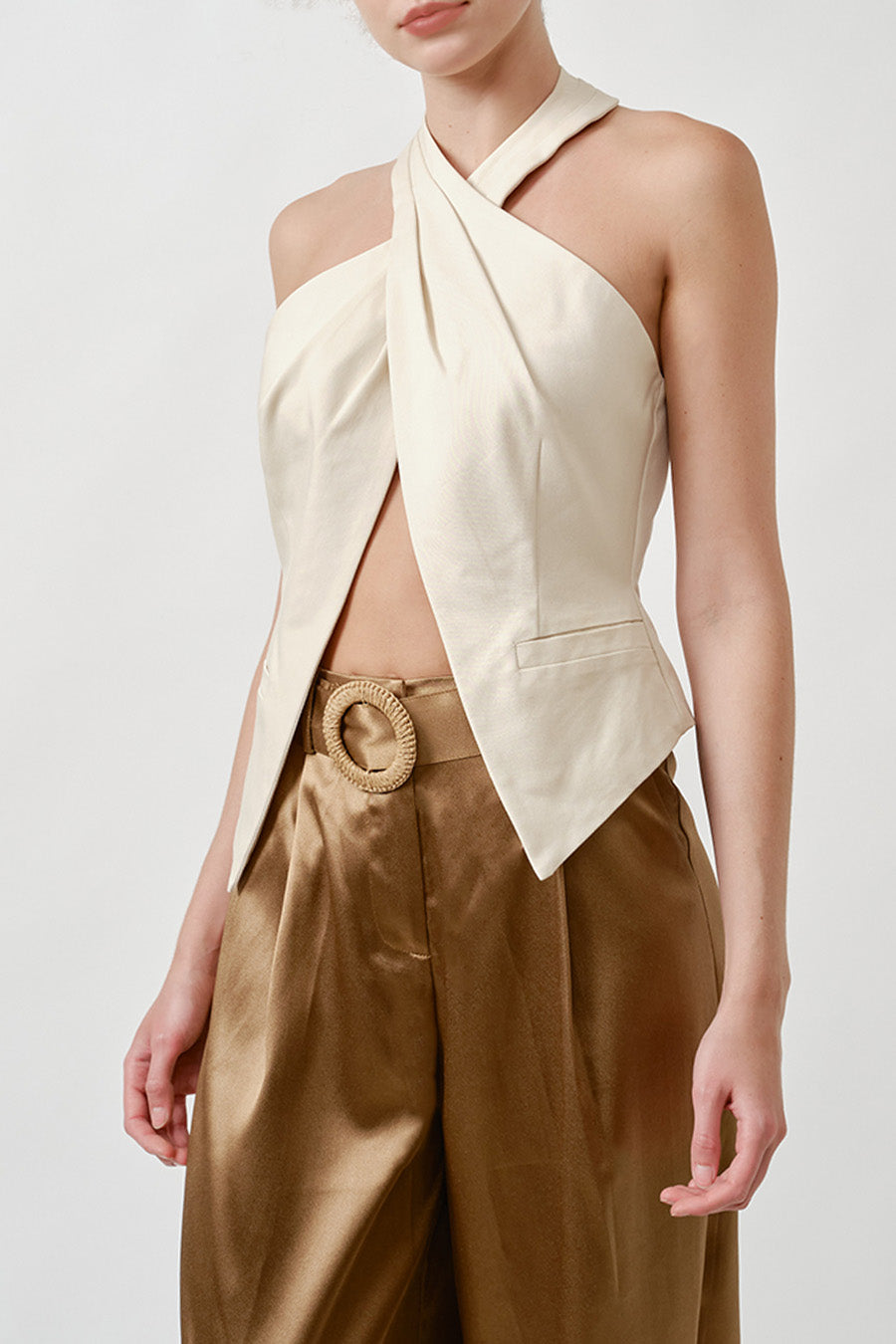 The crossover neckline creates a striking, architectural silhouette, while the open front adds a refined sense of allure without excess.