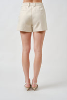 Crafted in a classic ivory tone, the minimalist design offers endless versatility—perfect for pairing with tailored tops, lightweight knits, or statement blouses.