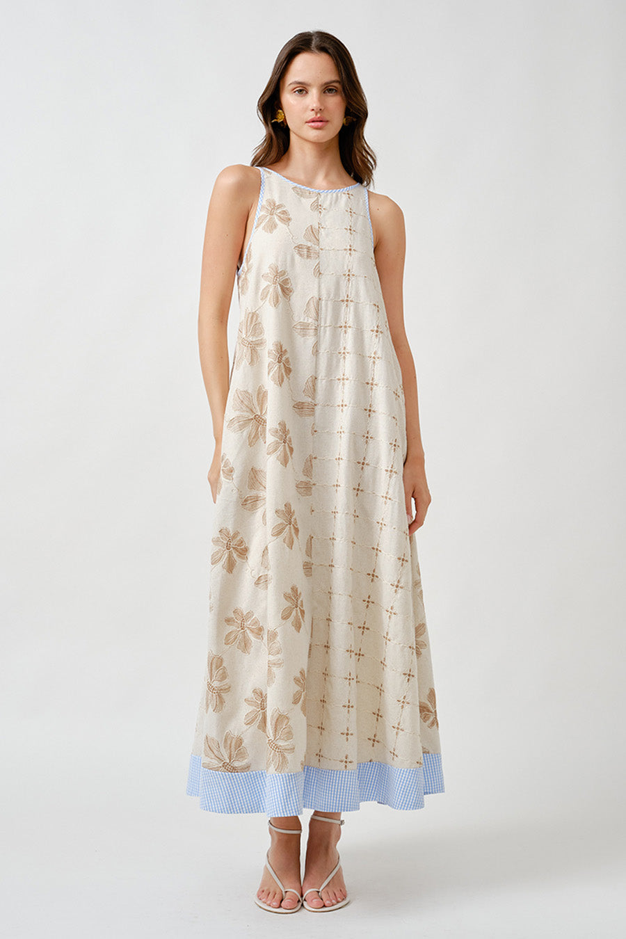 An elegant interplay of texture and pattern, this sleeveless midi dress is crafted to embody effortless sophistication.