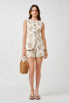 A refined expression of modern tailoring, this sleeveless vest top is crafted from richly textured jacquard adorned with an elegant tonal floral motif.