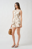 Designed to contour the silhouette, it features a clean button-front closure that enhances its sculpted, feminine shape.