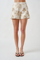 A refined expression of understated elegance, these tailored shorts are crafted from a beautifully textured jacquard fabric adorned with tonal floral embroidery.